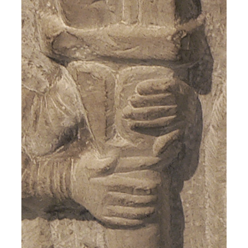 the hands of one of the figures hold a column of the arcade [cf. Font notes]