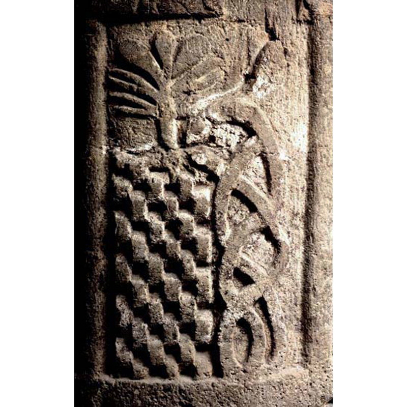 the panel includes a possible pair of intertwiined serpents and a plant or tree on a tall checquered base; identified in one source as the Tree of Life in the Garden of Eden, part of the Fall of Man