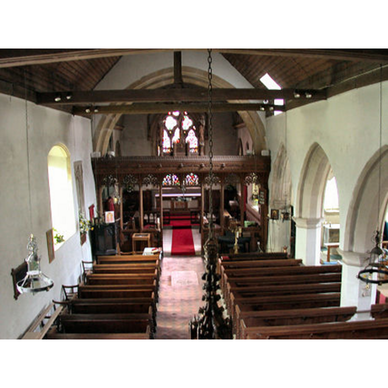 in the foreground, at the centre, the finial and the hanging chain of the old font can be seen
