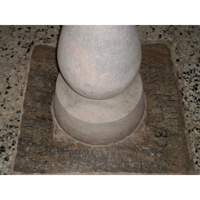 the marble stone under the font; the font itself is modern; the Latin inscription at the foot of the font has dates 1673 and 1734