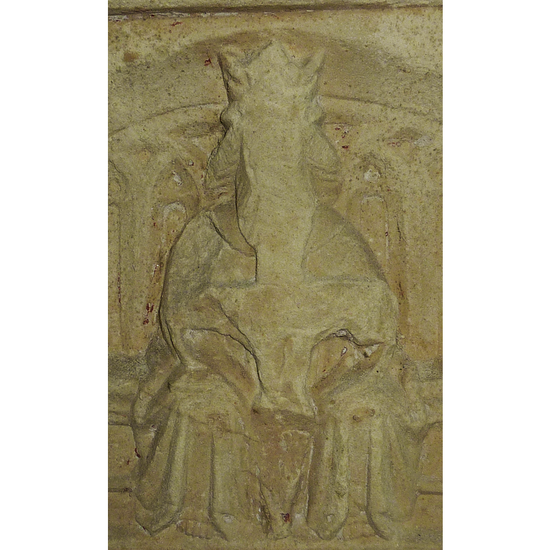 God the Father crowned; the face of God has been defaced; the shape of the gap in the centre of the figure appears to correspond to the traditional represention of the Trnity in the scene 'Pity of the Father', in which God holds a smaller crucified Christ in his arns, and often includes the Holy Ghost; these two may have been chiseled off at some point in the history of the font