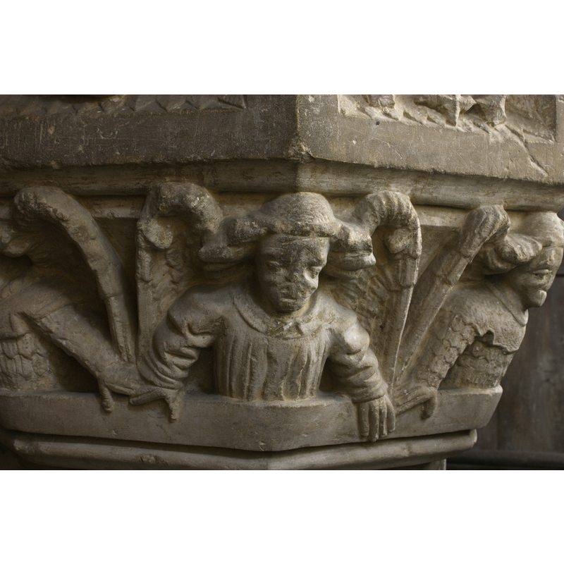 of the 'big-hair' type common in some East Anglisn fonts; some wear dressy tops; others appear to wear partial armour; all stand with their hands over the lower moulding, their hands touching, as spectators watching a show from a balcony