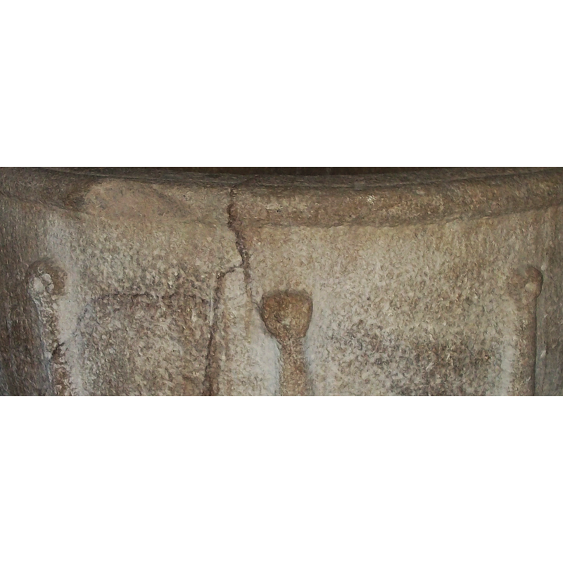 the donought-like endings of the vertical mouldings on the sides; notice also the significant damage on the left side