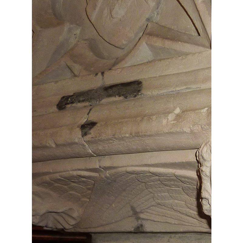 an old staple used to bind the cracked stone; notice that the crack goes all the way through the re-carved cherub wings on the underbowl side