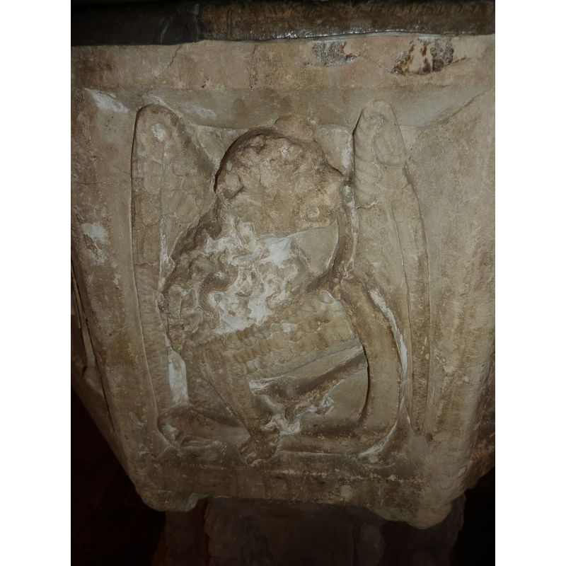 one of four such symbols, alternating with angels holding shields on the sides of the basin; this is on the northeast side