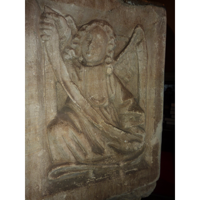 one of four such symbols, alternating with angels holding shields on the sides of the basin; this is on the northwest side