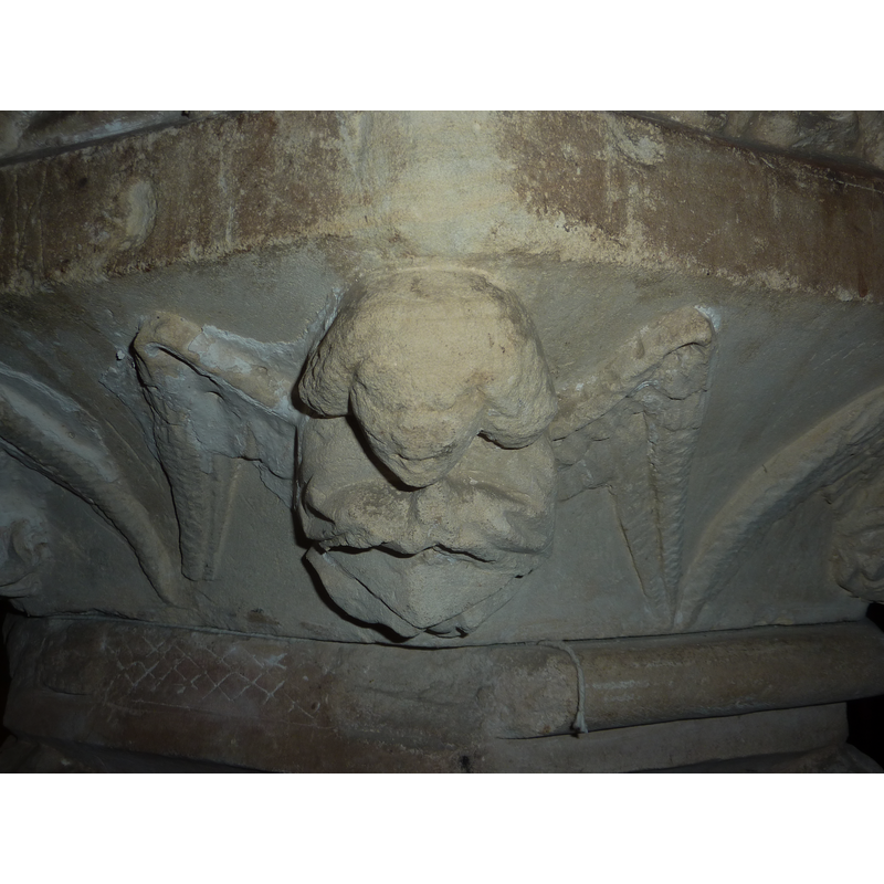 or holding an unidentified object; the cherubs are damaged and the identification is tentative