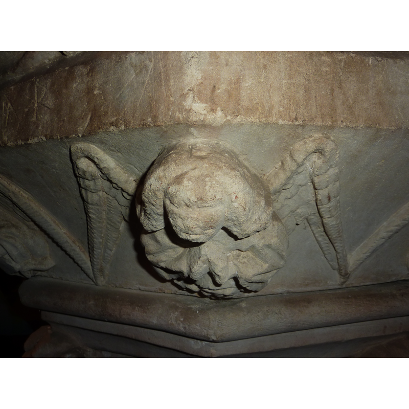or holding an unidentified object; the cherubs are damaged and the identification is tentative