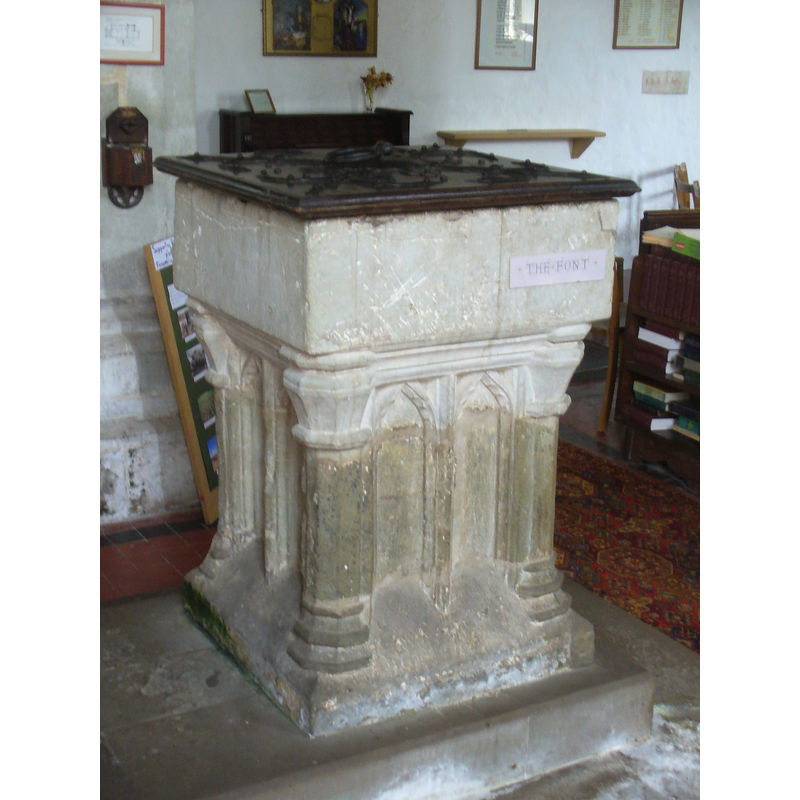 carved on the angles of the base, rather than 'clustered'