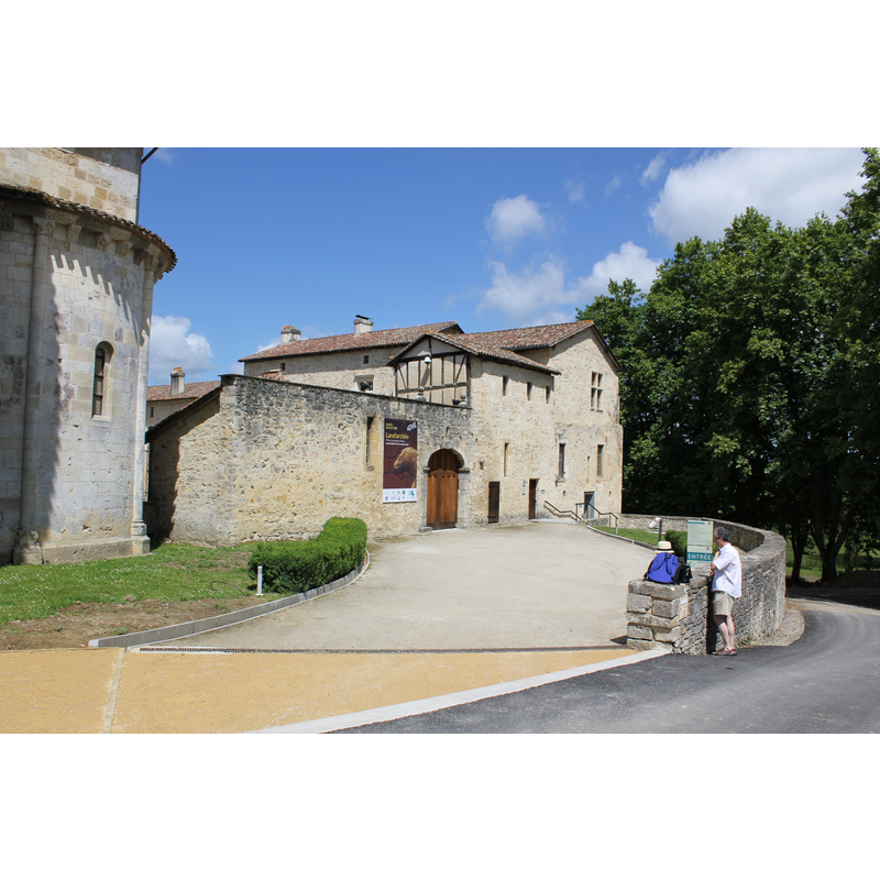 the abbey building with a partal view of the apse of the church