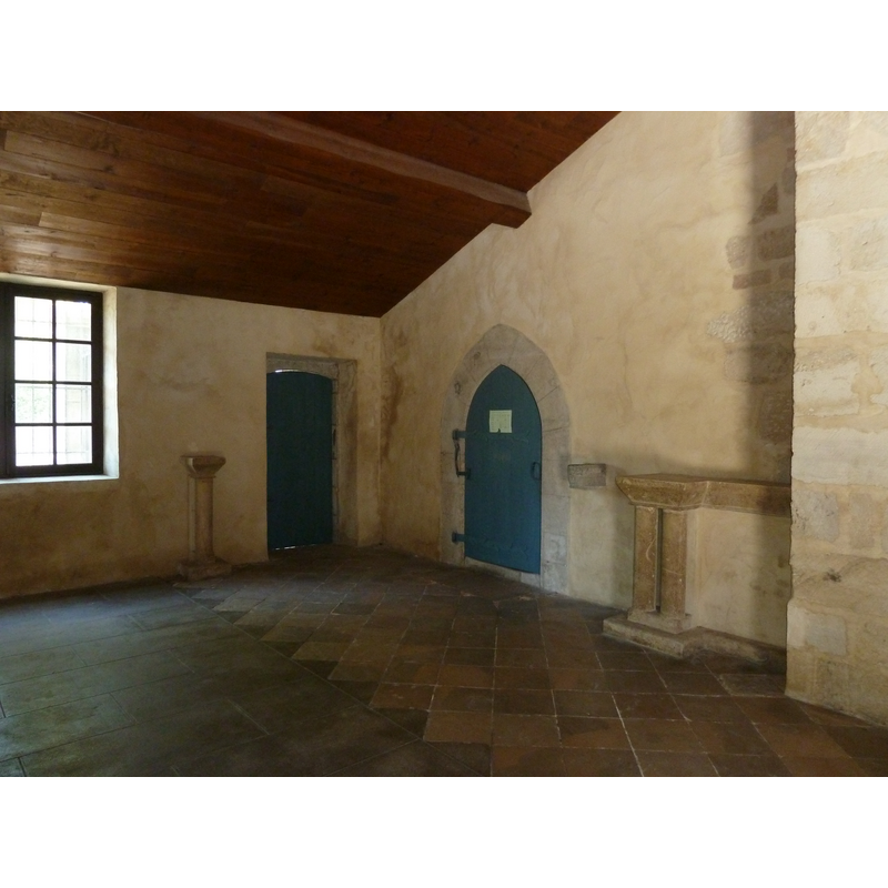 the wall-mounted stoup visible at the right of the pointed-arch door
