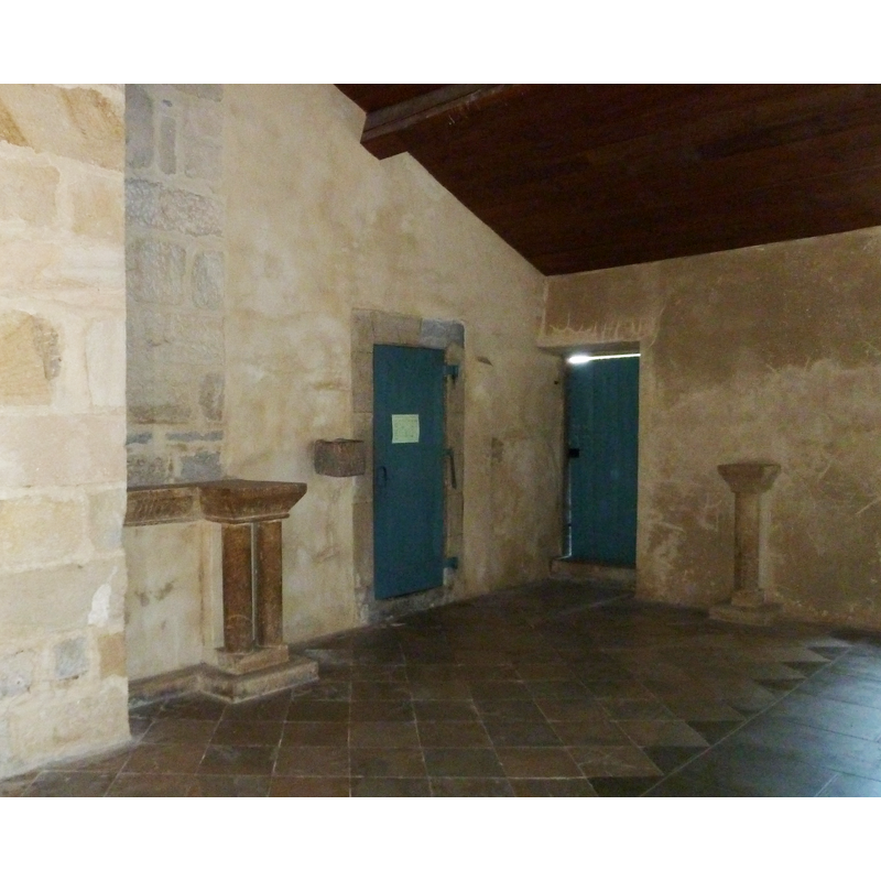the wall-mounted stoup visible by the left door