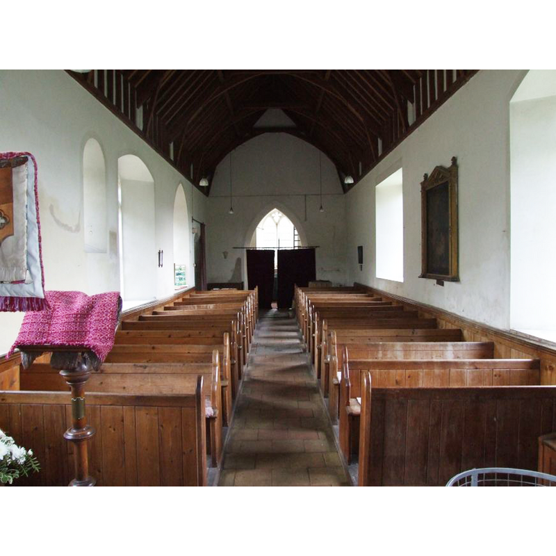 the top of the font is visible at the back (west), behind the right (north) bank of benches