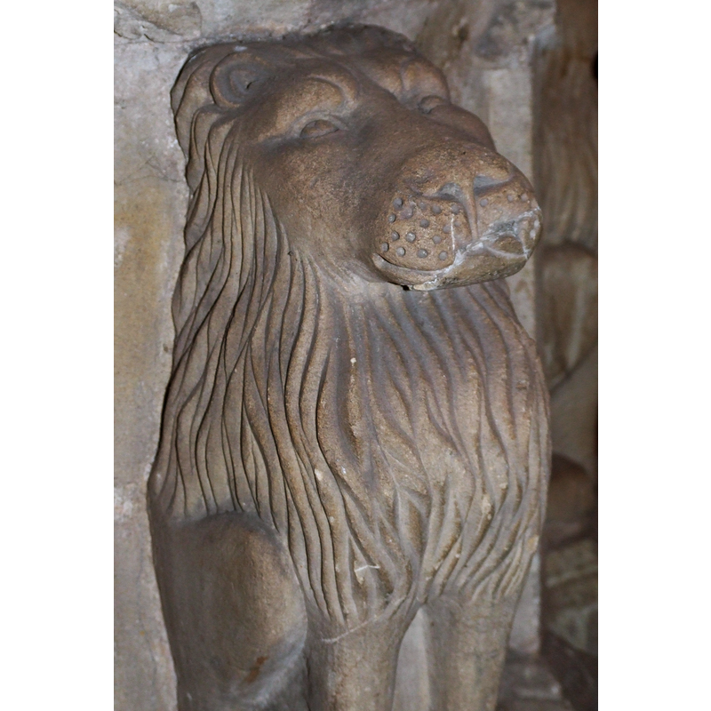 one of the four lions at the angles of the pedestal base