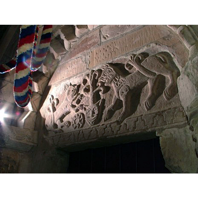 facing lions at Tree of life with mask on the Romanesque south portal tympanum