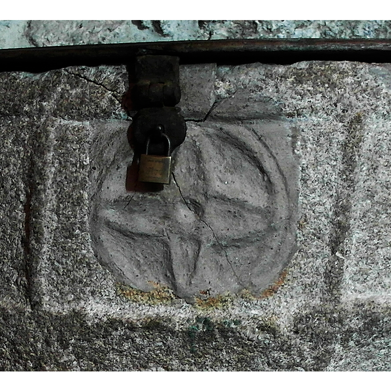 note the cemented patch and un-matching motif around the lock hasp and anchoring