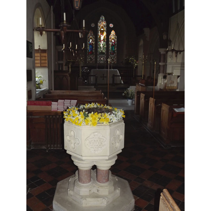 the modern font, located at the west end of the nave