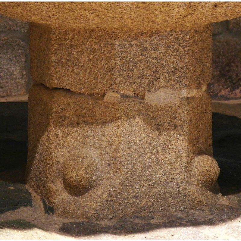 one on every other side of the octagonal base, the sides that chamfer in to make the transition of the pedestal  base from octagonal to square