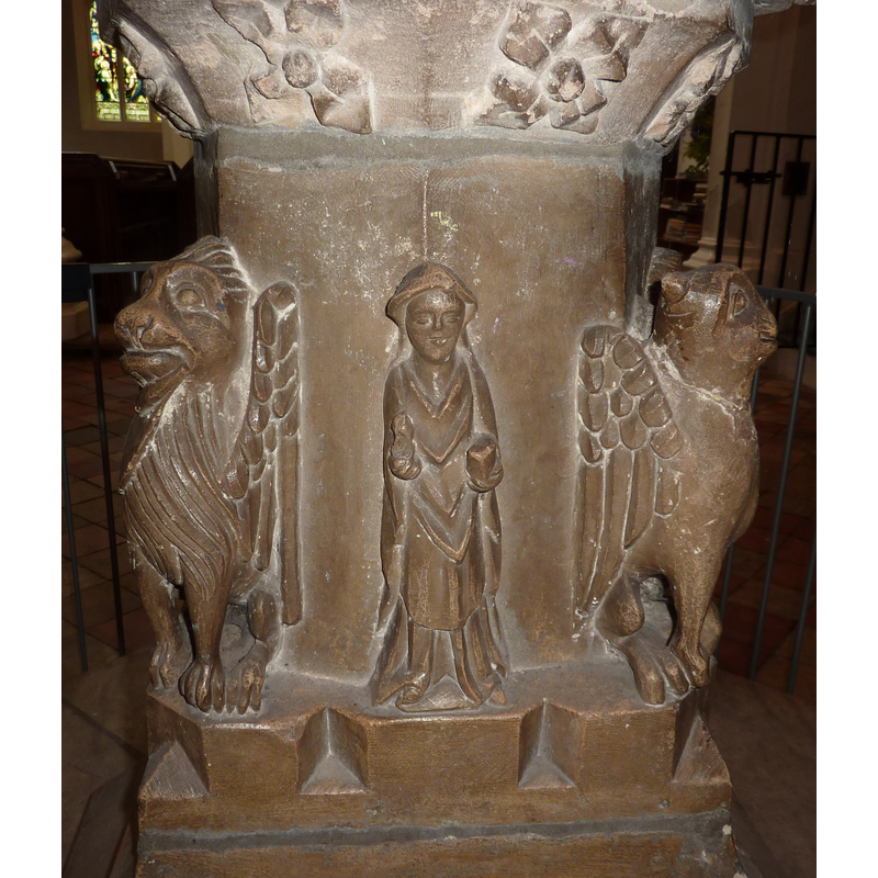 the top of the crenalltion serves as the stand for the human figures and the Evangelists' symbols