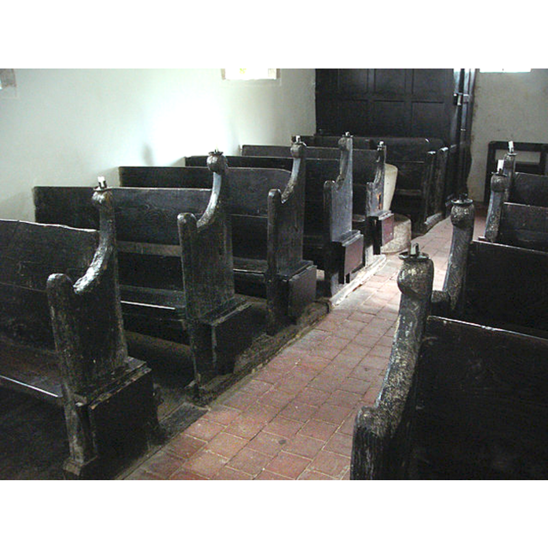 the font is partially visible among the back pews, in the southwest corner