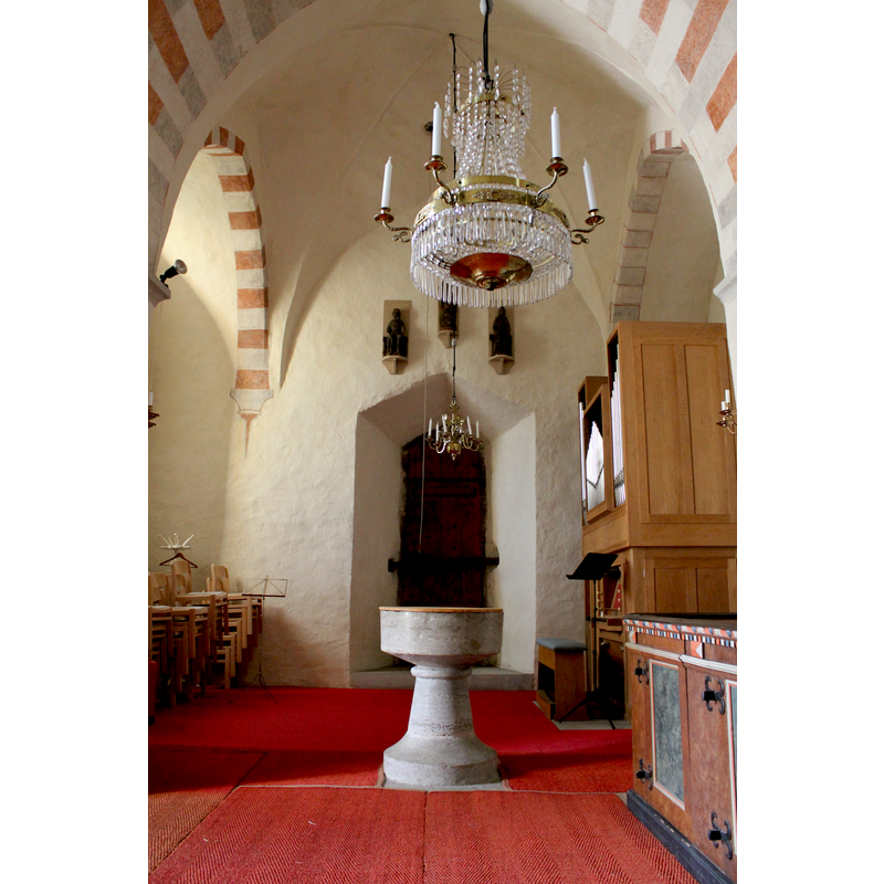 at the west end of the nave, beneath the tower arch