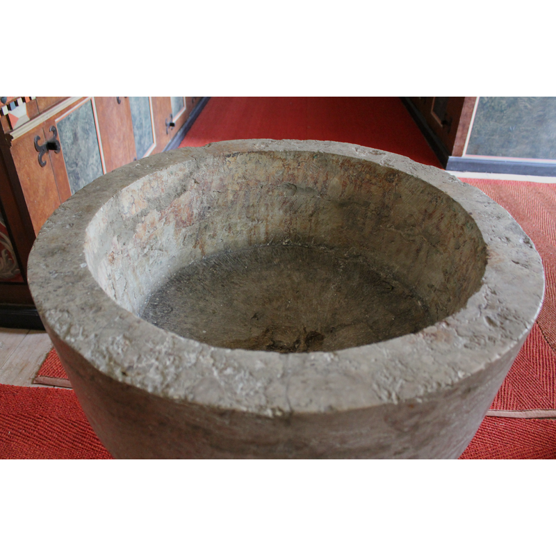 the mark or damage at the center of the inner basin is not related to the drain (there is none) but to a flaw in the stone