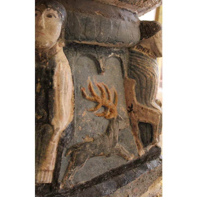 on the south side of the base, under above figure of Christ on the basin. Running Stag facing right; large antlers.