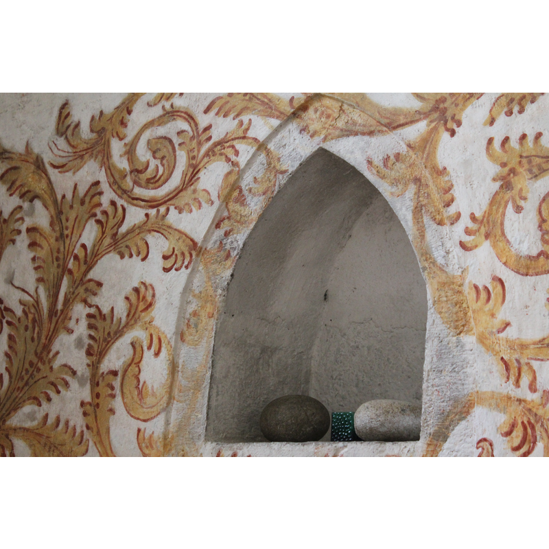 the little alcove contains two stones of the type used in Scandinavia to warm the water inside the font before baptism