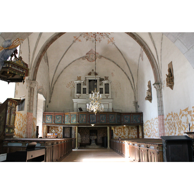 the font and cover at the far end, beneath the west gallery