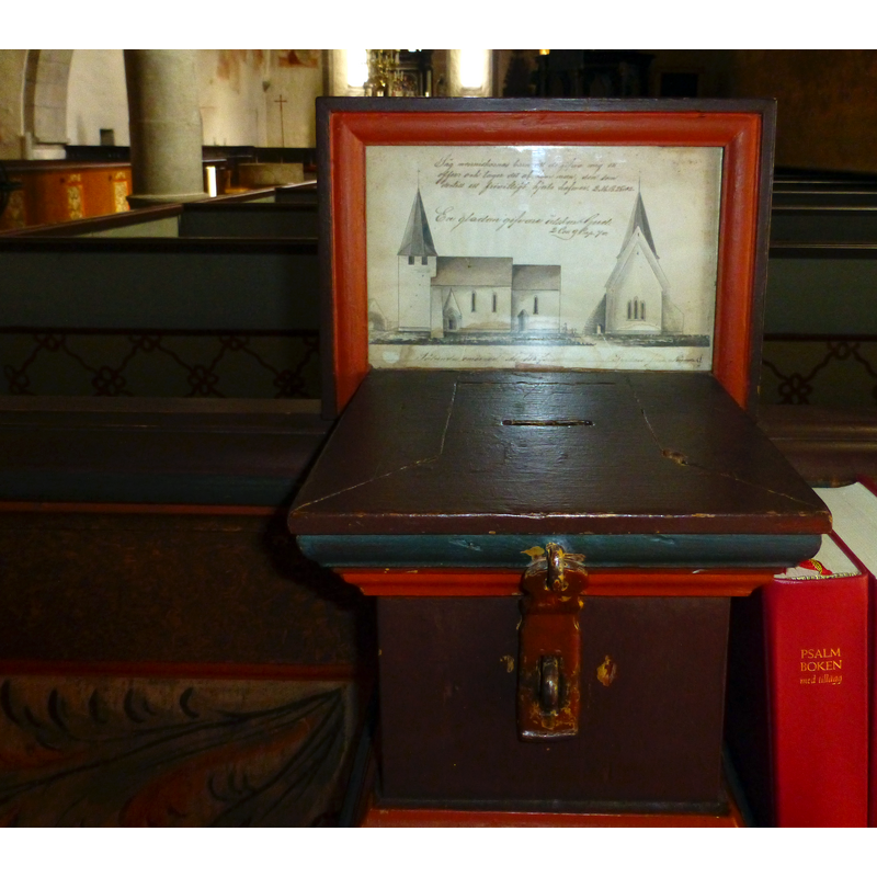 the later wooden moneybox; on it, an old photograph of the church here