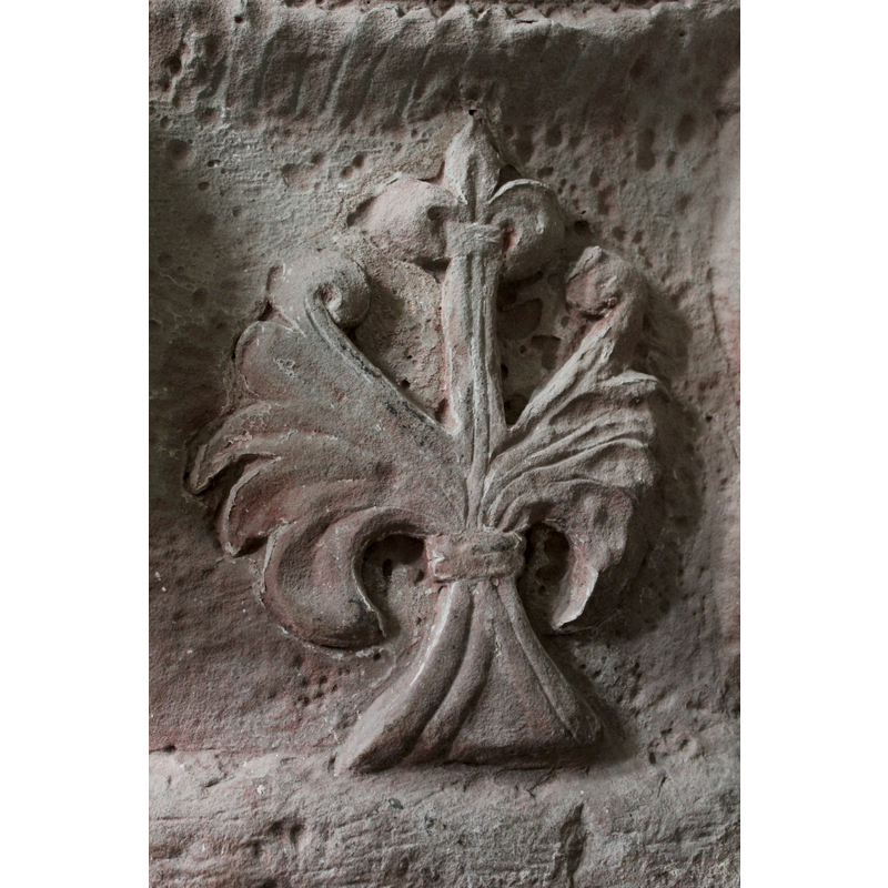 on the north side of the font -- oriention is approximate -- acanthus with fleur de lis atop; Tree of Life (?)