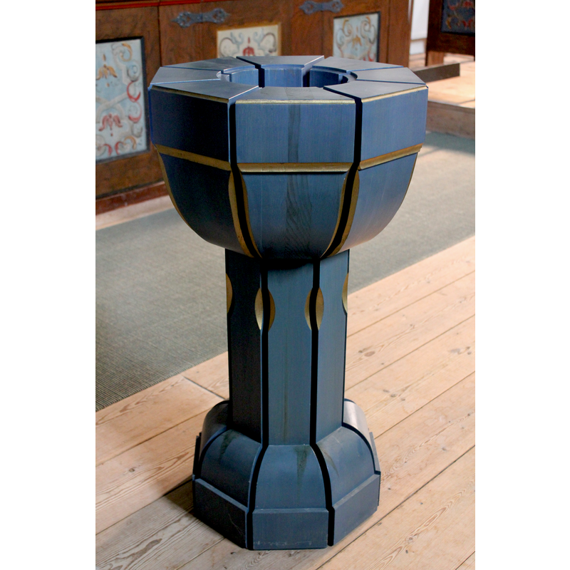 the modern font in use for baptisms; it is made of wood and accommodates a metal basin that holds the baptismal water