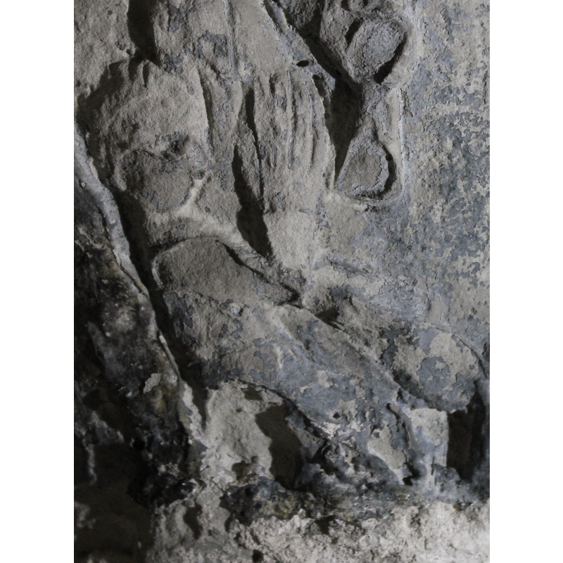 beneath one of the Passion scenes; two standing figures facing each other; the one on the left wields a battle ax; the figure on the right wields a sword; in the bottom left corner is a seated or semi-lying figure with hands together in prayer