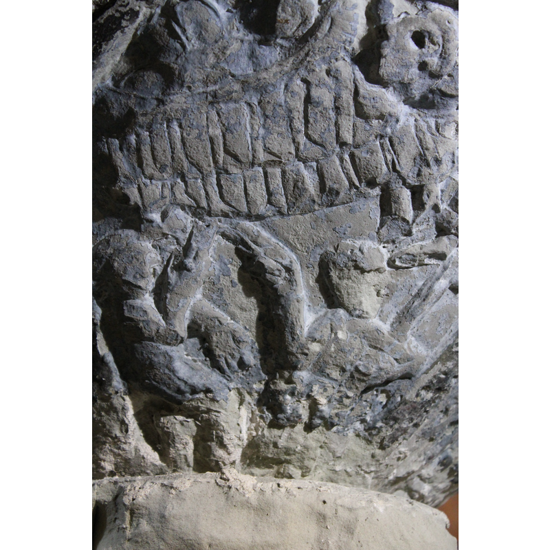 the two seated figures pointing up