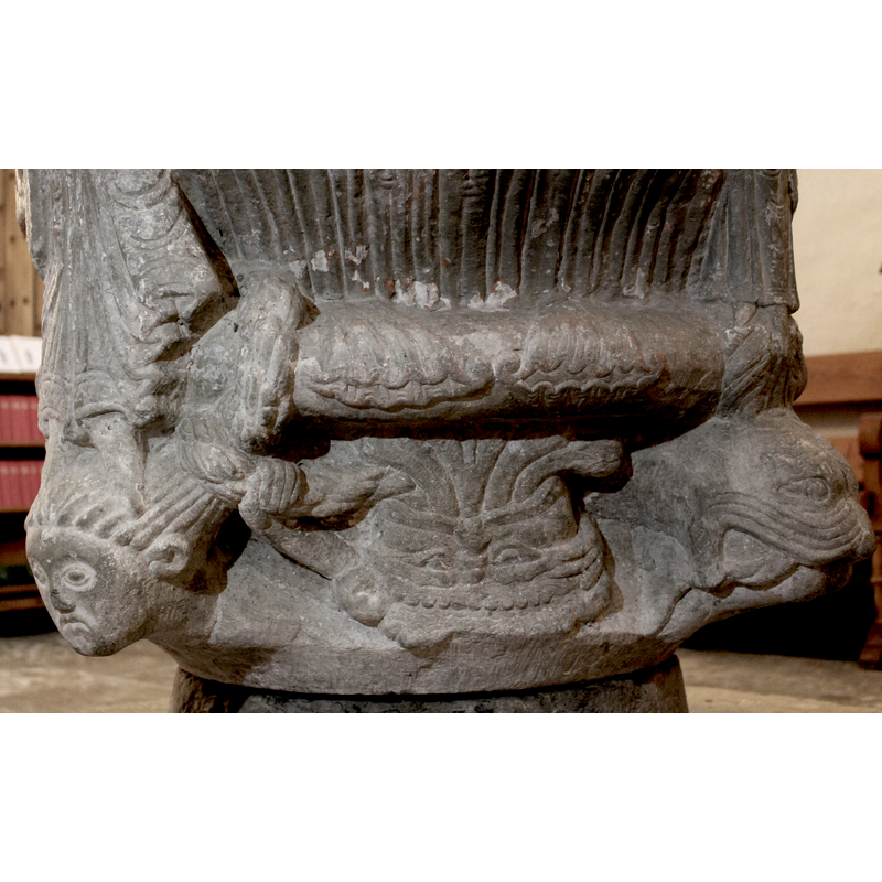 beneath Gabriel -- an upside-down head from whose mouth four volumes flow, perhaps a symbol of the four rivers of Paradise; the head is grotesque and wears a crown (?); one of the braids of the woman on the left is partly in its mouth or beard