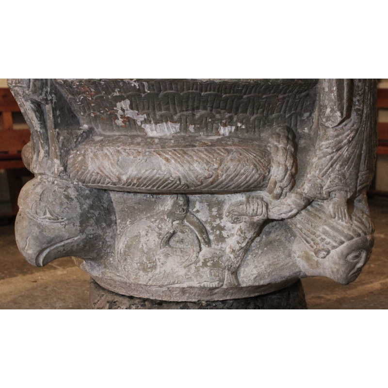 the two long parallel and straight pointed horns are clearly not those of a stag or a ram, the two most commonly bovids that appear on Scandinavian fonts; the animal resembles an ibex [capra pirenaica] or some other species of mountain goat-- the animal's neck is bent backward, perhaps wounded? The lower portion of the body is missing. The lower part of the base appears to have been cut.