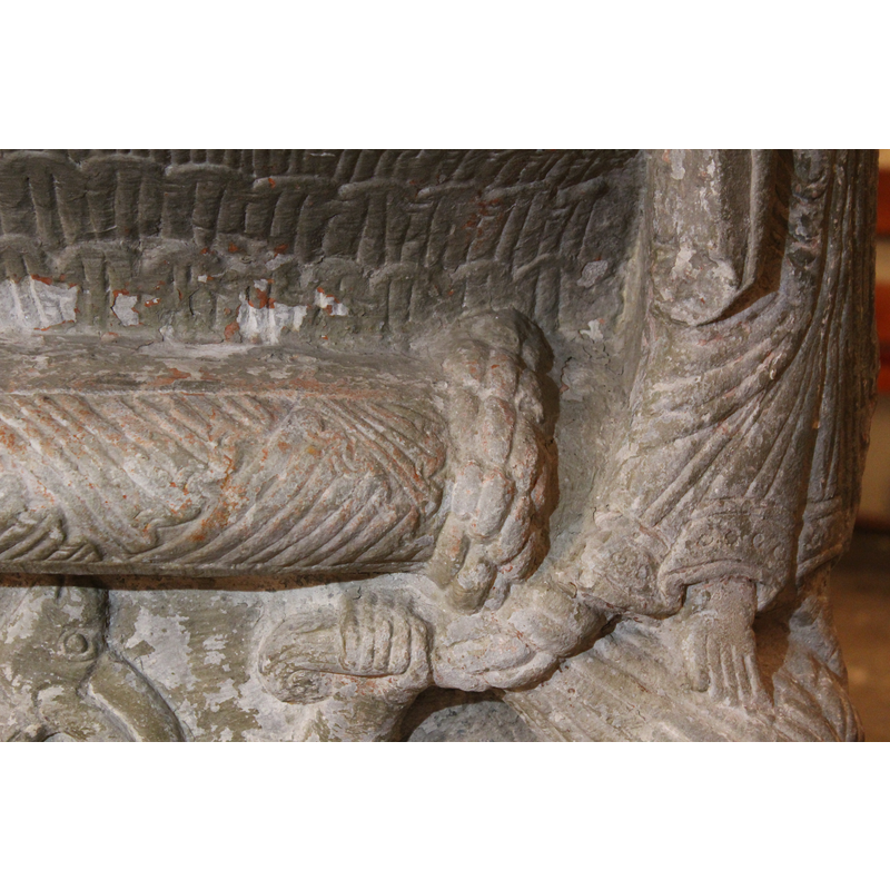 an area of the ring moulding is patterned with large acanthus leaves; visible here is one of the two instances in which the braids of the woman below are wrapped around the moulding