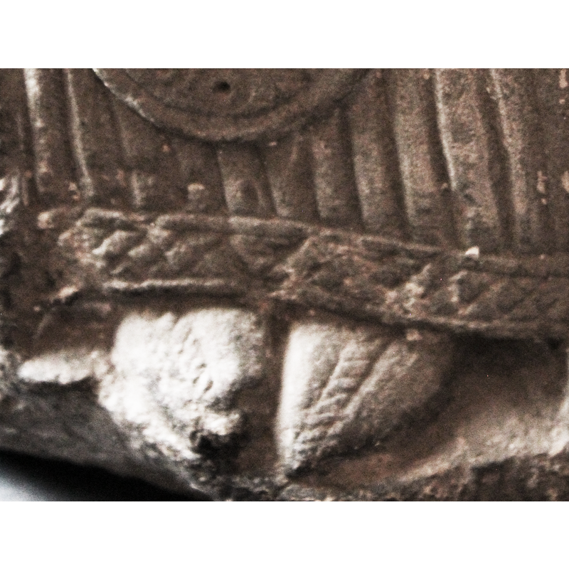 although the head and part of the staff or crozier are broken off, the clothes suggest this seated figure is a bishop -- notice the embroidered pointed shoes