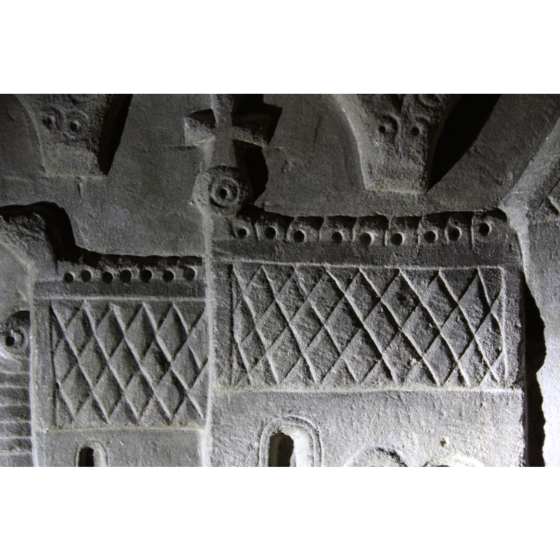 the roofs of the chancel (left) and nave (right); the presence of the animal [dragon?] head on the left, and the two ridges at the apex, and the reticular pattern of the sides of the roofs suggests a thatched roof;