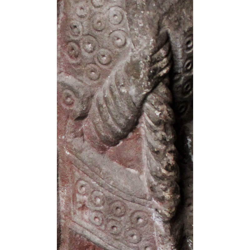 detail of the seat and the hand holding the remains of the staff or crozier; the pattern on the chair is identical to the one on the mantle of the figure