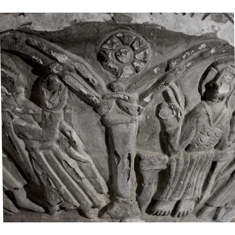 the capitals made of crude interlace; the arch-heads are double; the bases roughly triangular, some larger and decorated with incisions