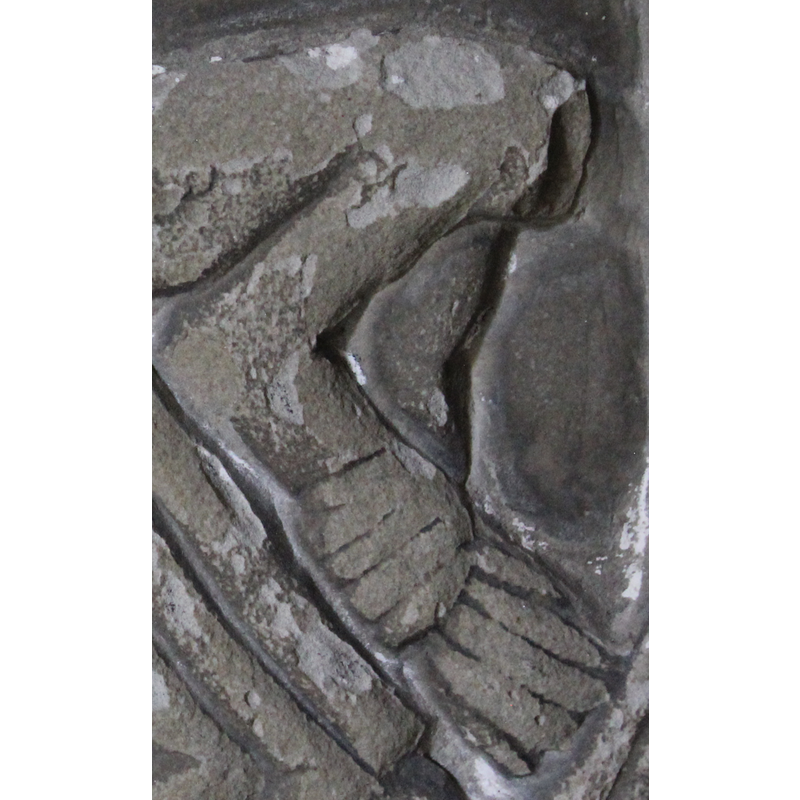 the decapitated (?) figure bending forward and holding her right arm, a symbol of grief