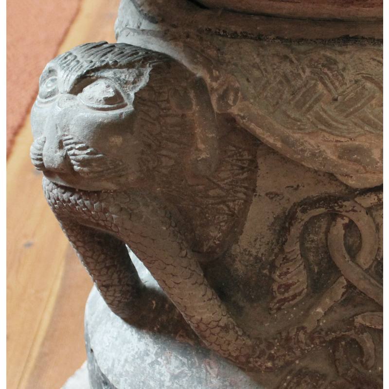 the tail of the snake is shaped like an acanthus leaf
