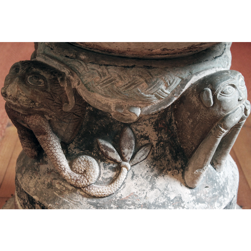 tail coiled and ending in a trefoil shape