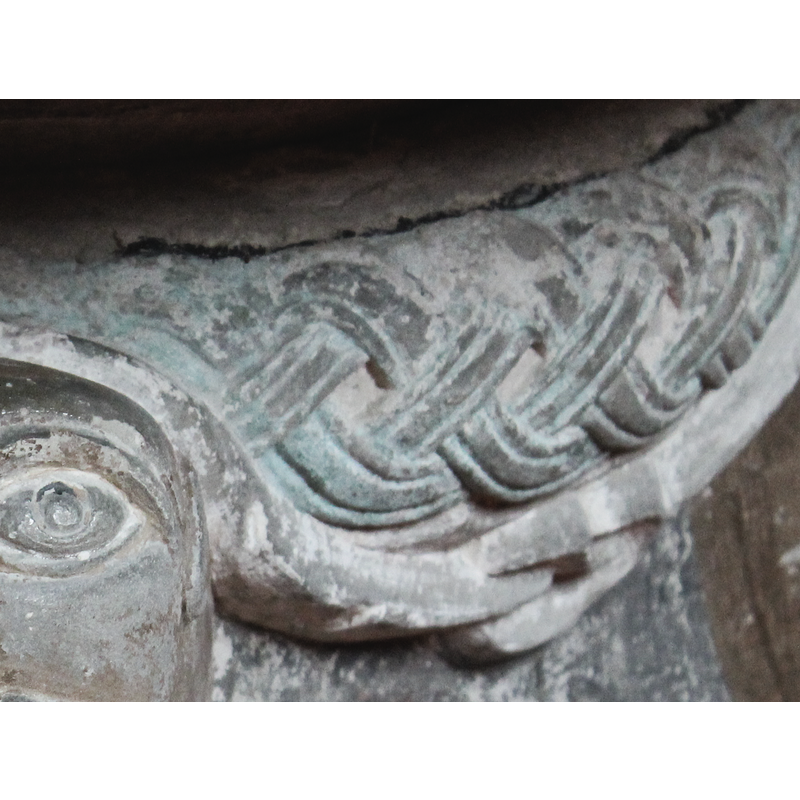 notice just below the interlace the head of a snake biting the tail of another