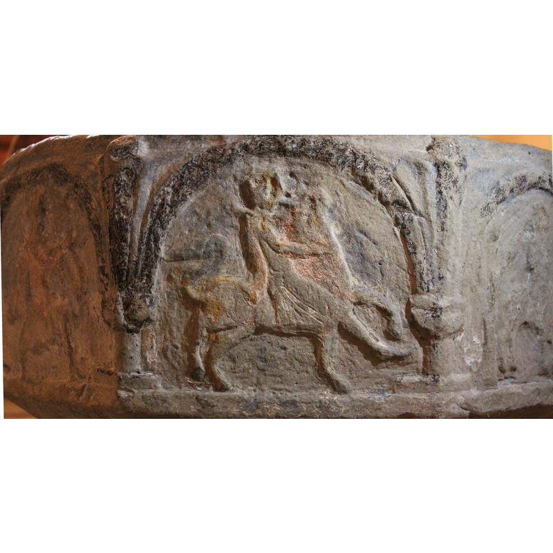 on the east side of the basin  -- a man riding [fighting?] a lion.