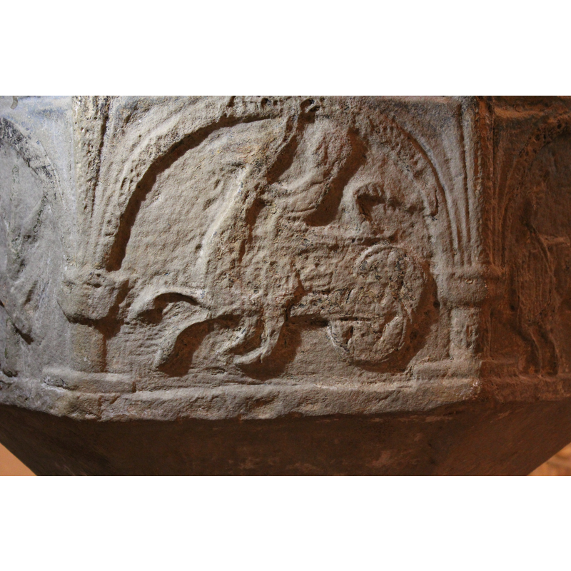 on the north side of the basin -- a human riding or fighting a aspis - facing left.