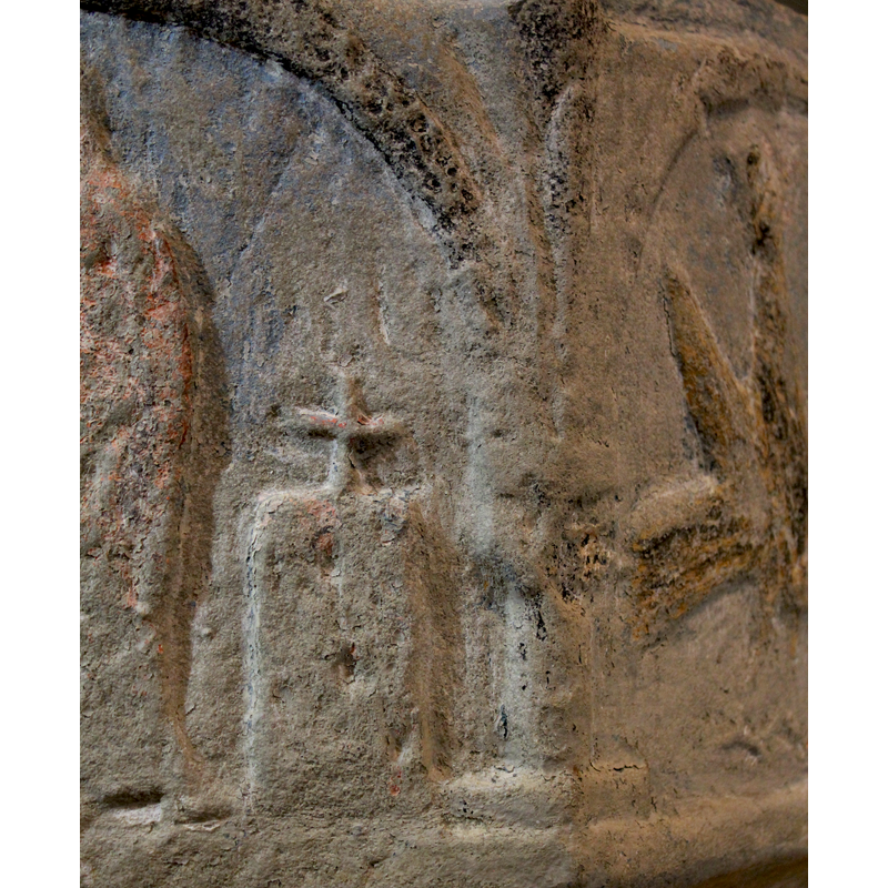 on the west side of the basin -- two haloed figures standing to the left of an altar with a cross on it -- the haloed figures