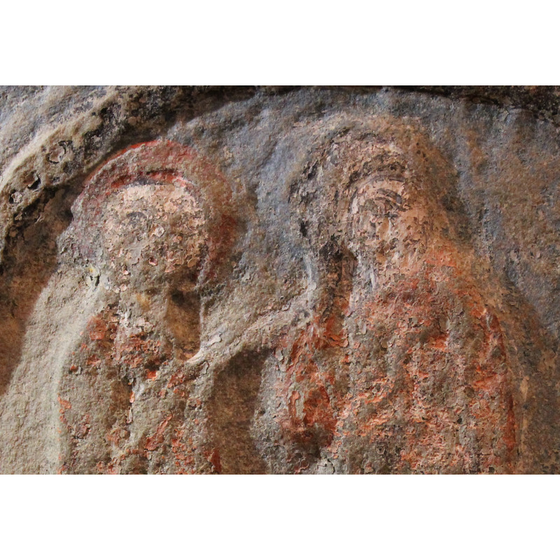 on the west side of the basin -- two haloed figures standing to the left of an altar with a cross on it -- the altar