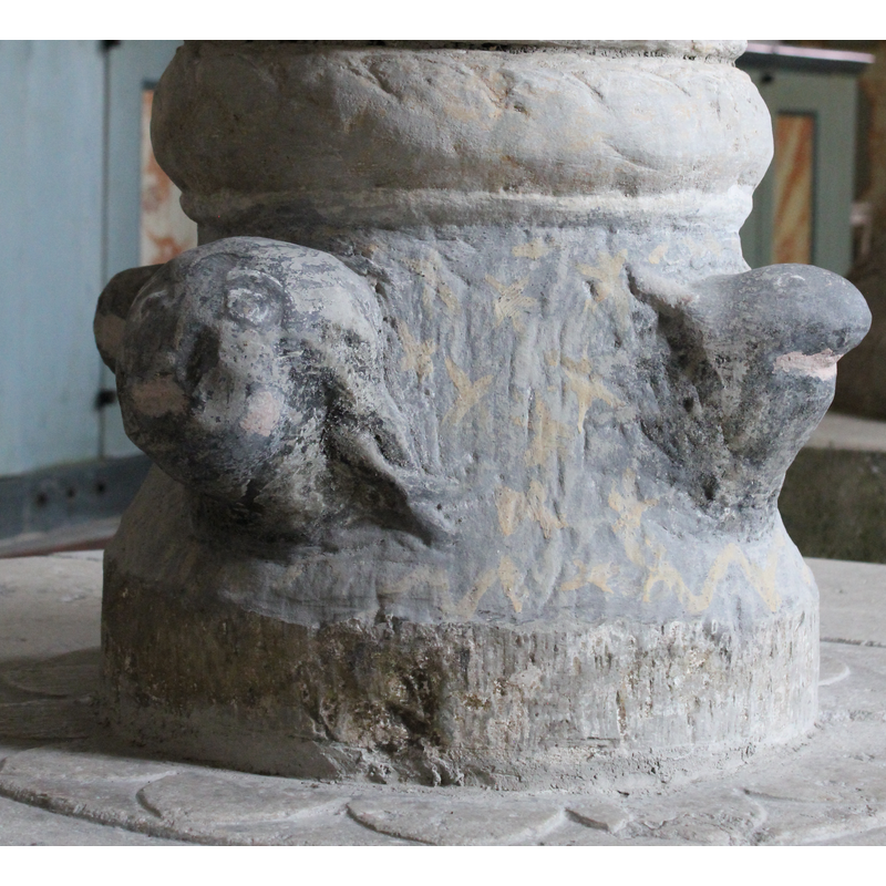 on the west side of the base [orientation is approximate] -- Like the other three heads, now very eroded and painted over, which makes identification difficult